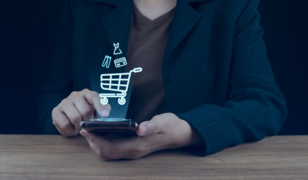 Businessman using smartphone shopping online, shopping cart icon on screen. E-commerce payment on internet. online supermarket gadget. Credit card safe, online business, convenience, competitive priceの写真素材