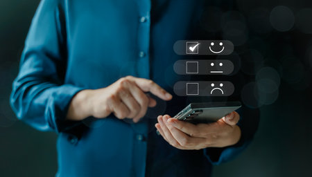 customer services best excellent business rating experience. Satisfaction survey concept. Hand of a businessman chooses a smile face on mobile feedback. 5 Star Satisfaction.の写真素材