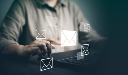Email marketing concept, company sending many e-mails or digital newsletter to customers. Businessman use laptop to send bulk documents via email. Direct selling projects in business List of customersの写真素材