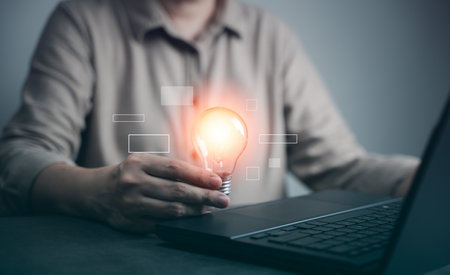Concept Innovation, inspiration, creative solution idea for modern business intelligence technology. Success creativity invention, thinking imagination digital marketing online. Hand hold light blub.の写真素材
