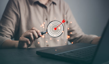 Magnifier glass focus on target dartboard, Business development strategy, and action plan concept of search, goal, strategy, success. magnifying, worker, talent, target, assessment, bullseye, crowd.の写真素材