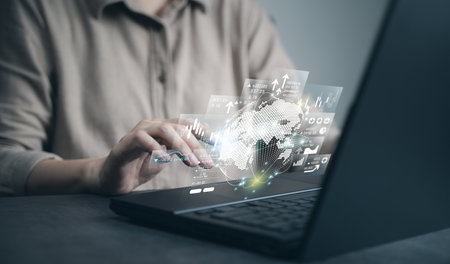 Man using laptop to analyze world global business economy. Concept of digital investment, analysis graph chart of financial growth, marketing network strategy, trading stock, future exchange market.の写真素材