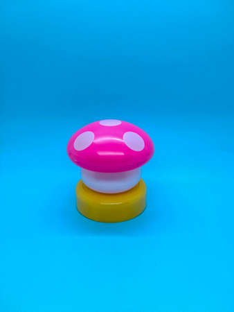 Toy mushroom shaped lamp on a blue background
