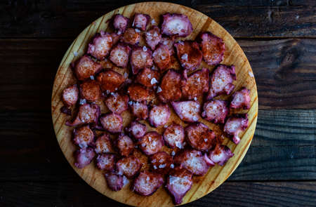 View of Galician octopus dish on old wooden backgroundの写真素材