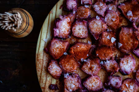 View of Galician octopus dish on old wooden backgroundの写真素材