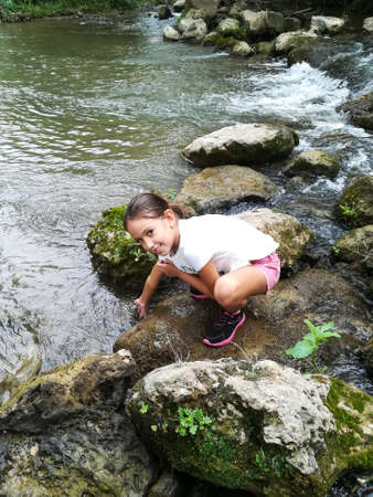 Smiling girl posing on the river Palancia as it passes through Segorbeの写真素材