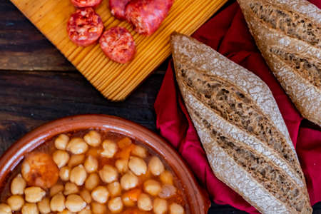 Chickpea dish and ingredients in composition on wooden backgroundの写真素材