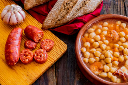 Chickpea dish and ingredients in composition on wooden backgroundの写真素材