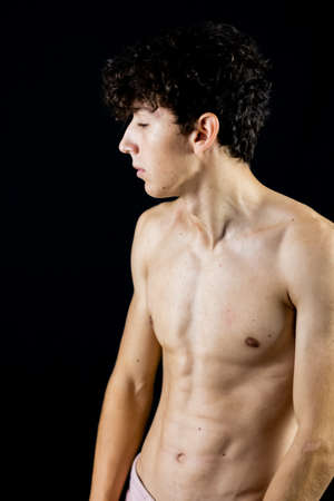 Portrait of young boy on a black backgroundの写真素材