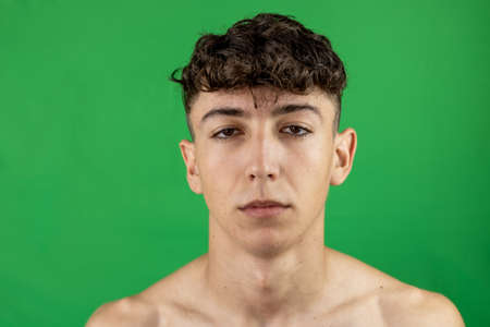 Portrait of young boy on green backgroundの写真素材