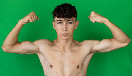Portrait of young boy on green background