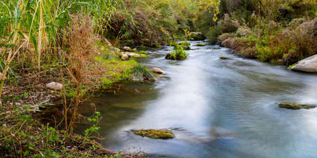 View of the river with rocks in long exposure