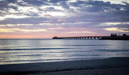 Jetty at sunrise on the beachの写真素材