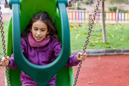 Little girl playing in the village parkの写真素材