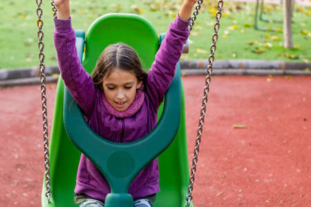 Little girl playing in the village parkの写真素材