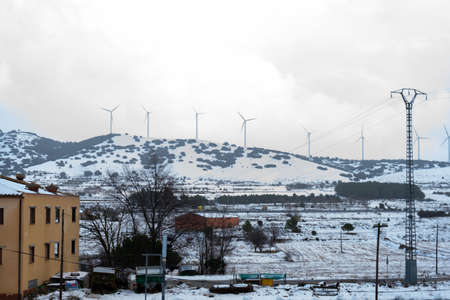 View of the snowy mountains with the electric mills in Barracas