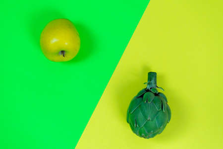 Conceptual image of artichoke and apple on backgrounds with inverted colorの写真素材