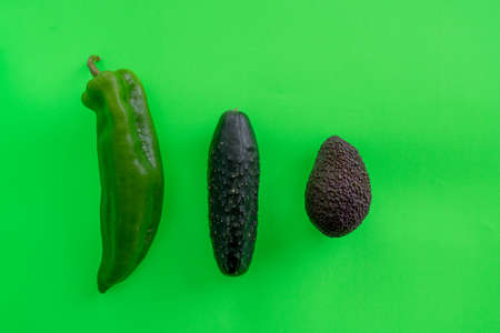 Fresh green vegetables and fruits on a green background in diet conceptの写真素材