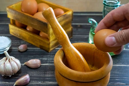 Garlic heads, eggs, salt, and oil distributed to prepare the ajoaceite sauce typical of Spanish food...