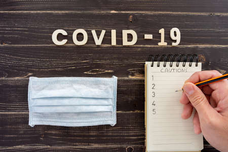 Conceptual image about coronavirus with wooden letters on old black wooden tableの写真素材