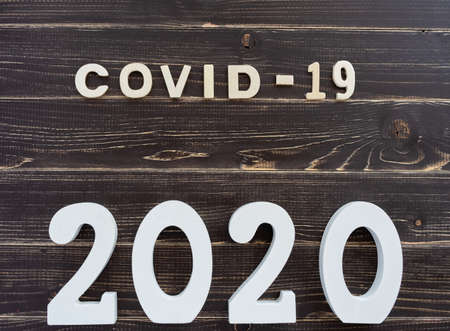 Conceptual image about coronavirus with wooden letters on old black wooden tableの写真素材