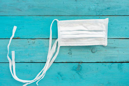 Conceptual image about coronavirus with wooden letters on old light blue wooden tableの写真素材