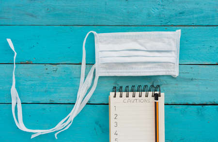 Conceptual image about coronavirus with wooden letters on old light blue wooden tableの写真素材