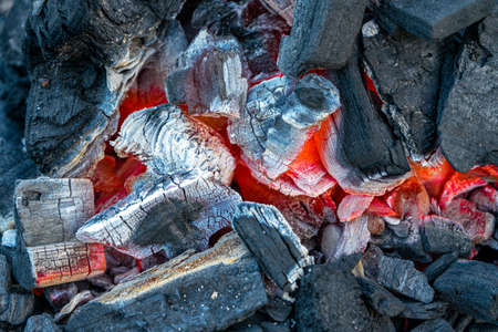 Incandescent charcoal embers with beautiful orange and reddish tones