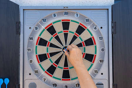 Target view of darts hanging on the wall of the terrace. Fun concept