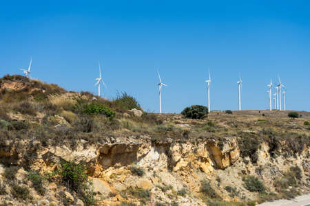 Mountainous landscape with wind energy mills mixing rural life with renewable technologies. Healthy life conceptの写真素材