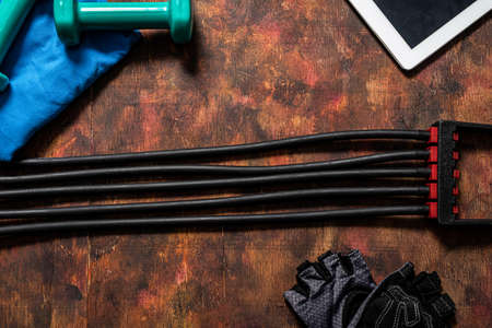 Weights and accessories for exercising at home and a tablet for an online workout.Healthy life...