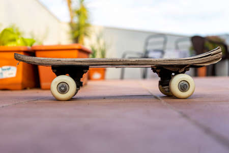 View of an old skateboard on the terrace of the house. Selective focus. Game conceptの写真素材