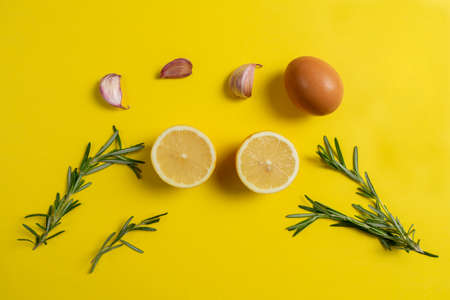 Fresh natural ingredients to produce the tasty garlic sauce of Spanish origin in composition on a yellow background. Healthy food concept, Mediterranean diet.の写真素材