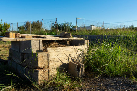 Artisanal composter built rustically, is full of branches and biological remains in rotの写真素材