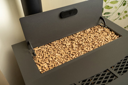 Image of a pellet stove with the hopper filled to the brim with ecological fuel, sustainable and renewable heatの写真素材