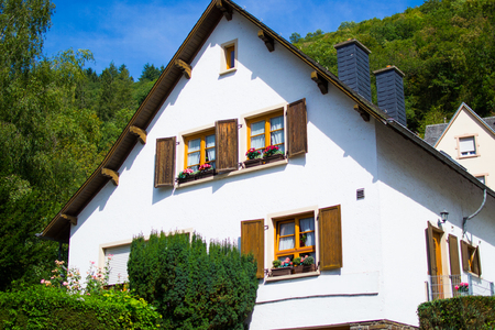 Typical house of Vianden in Luxembourg, with colorful flowers in the windowsの写真素材