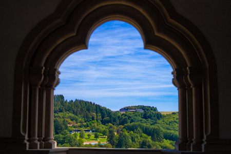 View of the mountain and forest in Vianden, Luxembourg, from an arch inside the Vianden Castle.のeditorial素材