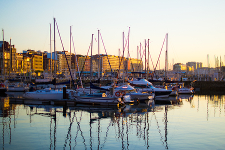 Sunset in the dock of Gijon, Asturias, Spain. Reflections of the boats in the waterのeditorial素材