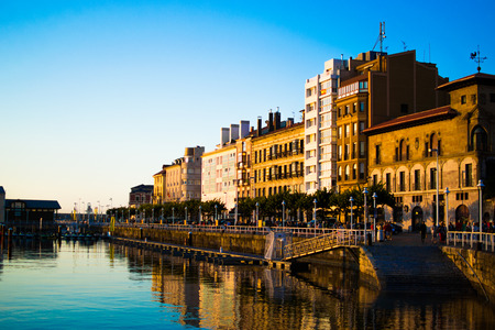 Sunset in the dock of Gijon, Asturias, Spain, with the reflections of the buildings in the water. Relaxing placeのeditorial素材