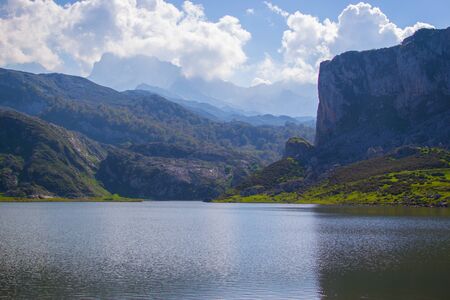 Nice views of Ercina Lake in Covadonga, Asturias, Spain. Green grassland with a glaciar lake and mountains at the backgroundの写真素材