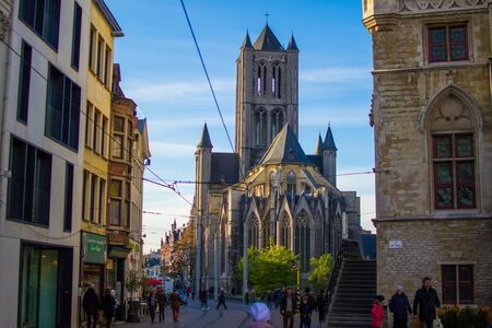 Ghent, Belgium; 10/30/2018: Facade of Saint Nicholas' Church (Sint-Niklaaskerk) between the buildings during a sunny dayの写真素材