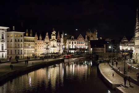 Ghent, Belgium; 10/27/2019: Most famous canal in Ghent, Belgium, with reflections of the illuminated...