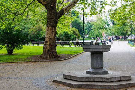 Fountain of the park in Peace Square (nÃ¡mÄstÃ­ MÃ­ru) with trees at the background, in Vinohrady, Prague, Czech Republicの写真素材