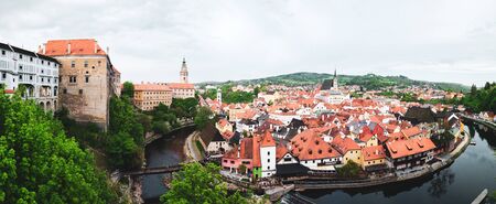 Aerial panoramic view of the typical colorful houses and landmarks of Cesky Krumlov with Vltava...