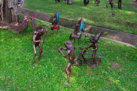 Traditional african handcrafted wooden statues of frogs in the garden of Cultural Heritage store in Arusha, Tanzaniaの写真素材