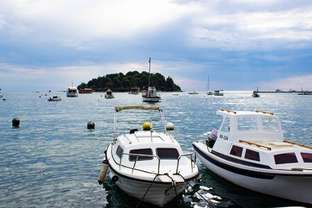 Rovinj, Croatia; 7/18/2019: Some boats on the Adriatic Sea, anchored in the coast of the old town of Rovinjの写真素材