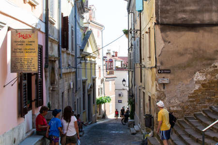 Piran, Slovenia; 7/19/19: Narrow alley with colorful slovenian houses in the old town of Piran, in Sloveniaのeditorial素材