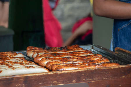 BBQ German Sausages being grilled by a vendor in Borough Market, Southwark, London UKの写真素材