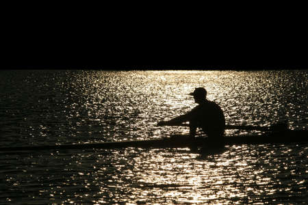 Rowing alone at sunsetの写真素材