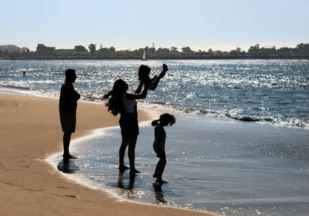 Happy family on the beachの写真素材